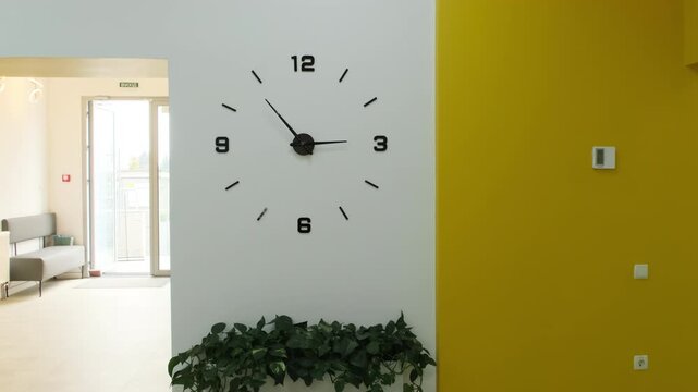 Large elegant clocks hang on wall of modern and stylish private medical facility. Clock allow patients and staff to easily monitor time. Slow motion