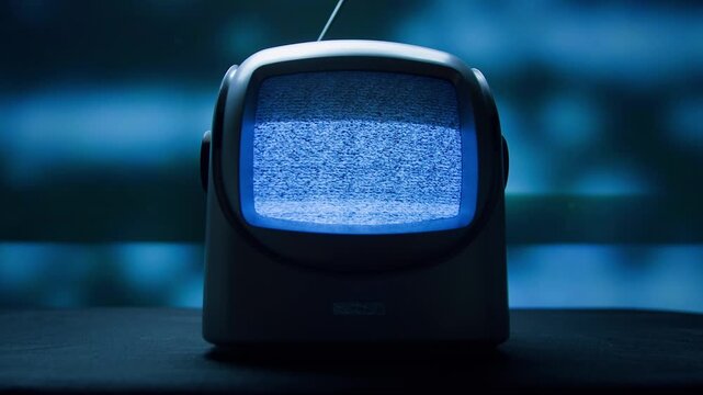 Retro TV, vintage television In a nostalgic setup, a retro TV displays grain on screen, scary halloween night device good for chroma key and green screen.