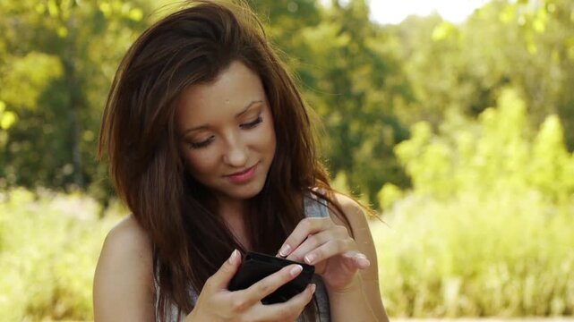 woman is typing with stylus on device