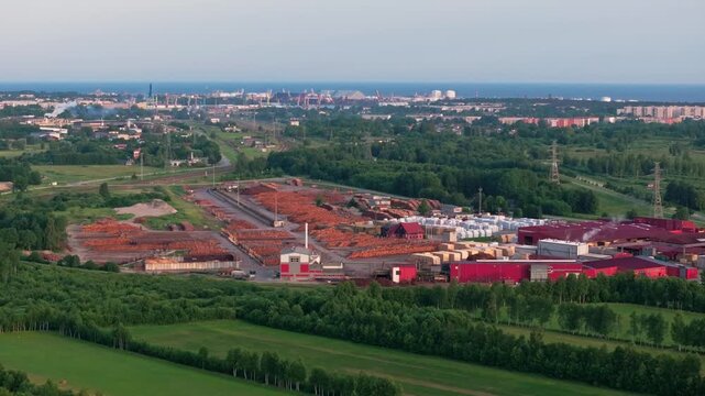 Aerial view of timber processing facility with Ventspils Port and Baltic Sea in Latvia