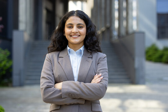 Young professional woman smiling standing with folded arms