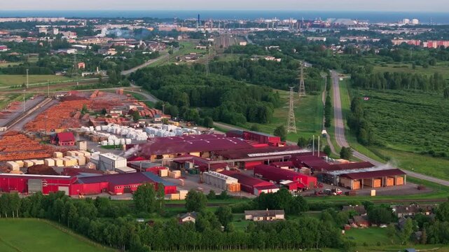 Aerial view of modern timber processing facility near Ventspils, Latvia with port in the background