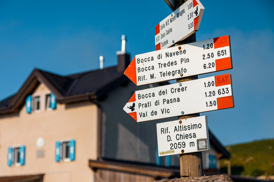Trekking signpost indicating mountain hiking routes for outdoor tourism and exploration at Altissimo Refuge "Damiano Chiesa", Monte Baldo Natural Park,Brentonico,Trentino,Veneto,Italy.