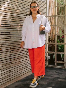 Portrait of woman standing outdoors near modern building