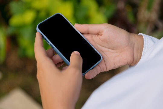 Close up smartphone in hand with blank screen