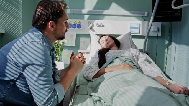 Grieved man sits near bed of beloved woman fighting disease