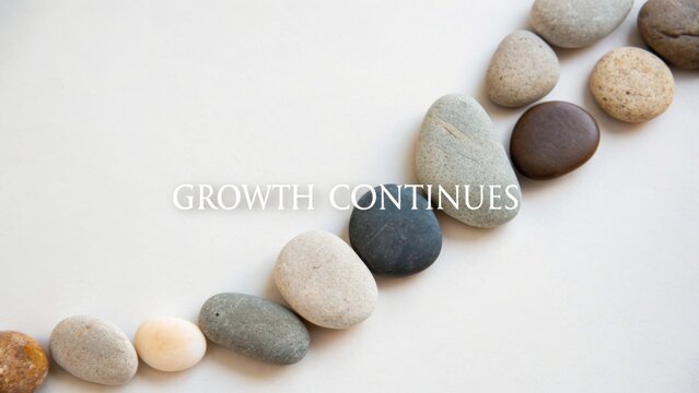 Natural Stones Arranged in a Line Representing Progress and Growth Continuity with Inspirational Text Overlay