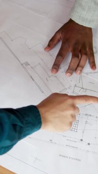 Discussion, blueprint and hands of construction workers on site for building, repairs or maintenance. Above, floor plan and architect with contractor for feedback on property development in workplace
