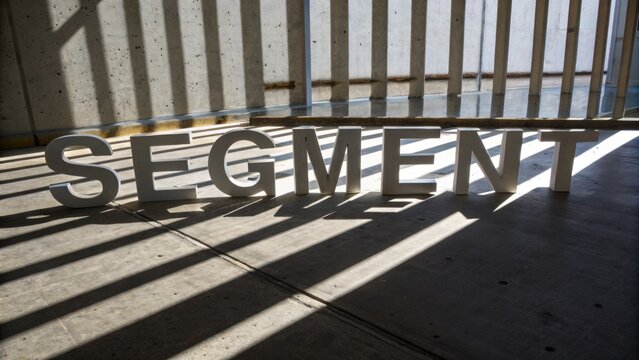 Shadows and Light Play on Letters Forming the Word Segment in an Urban Setting