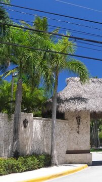 Entrance of Luxury Tropical Resort with palm trees. Caribbean travel destination. Nobody. Vertical footage