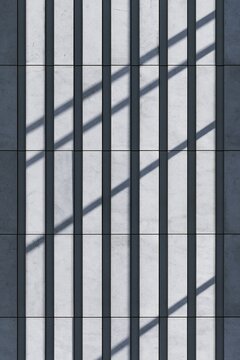 Abstract architectural facade with vertical and diagonal shadow patterns on concrete wall