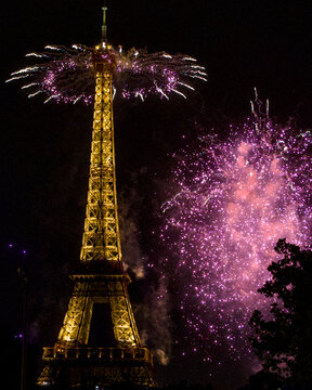 Purple fireworks crown the Eiffel Tower during Bastille Day celebrations in Paris France July 13 2026