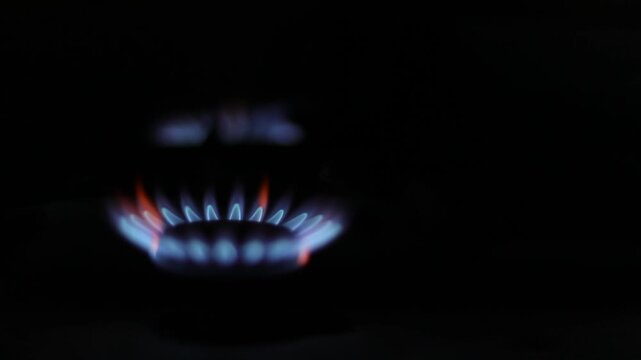 Blue gas is burning in the kitchen. Gas stove. Blue flame. Gas equipment.