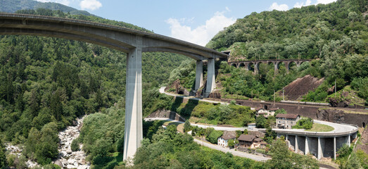 Naklejka premium Highway bridge in Ticino between Giornico and Lavorgo, with an aerial shot you can see all the communication routes, railway, highway and old cantonal road