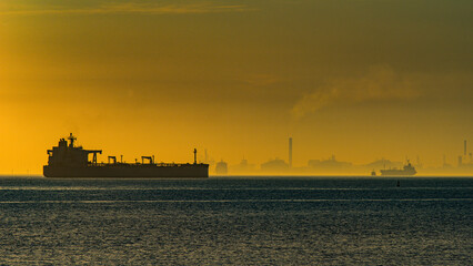 Tanker ship sailing past fos-sur-mer industrial port at sunset © Georges
