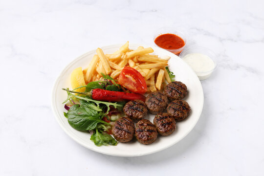 Grilled Beef Meatballs- Grilled Chicken Kebab with French Fries, Fresh Salad, Tomato and Garlic Sauce