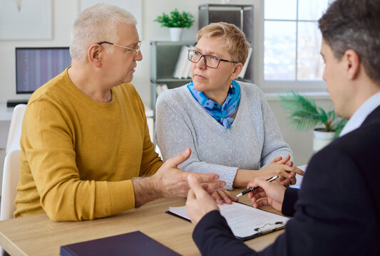 Senior couple and advisor in investment meeting. They discuss retirement consultation, compare finance options, and move toward agreement and signing. Clear retirement finance planning theme.