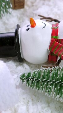 Different christmas objects lay out on snow background. Rotate. Winter holidays. New Year greeting card. Vertical footage
