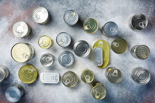 Aluminum cans with canned goods. A large set of canned goods in cans. On a gray background.