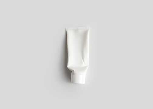 White Cream Tube Packaging Mockup on Gray Background Top View