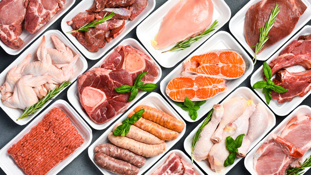 raw meat and fish in plastic trays from supermarket. Top view.