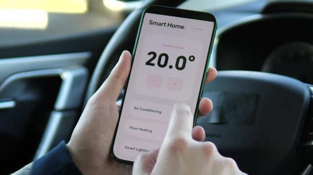 Close-up of a hand precisely adjusting the home temperature from 22 degree to 20.5 degree on a smartphone app. User tapping the minus button. Ideal for IoT devices, climate control, and smart living