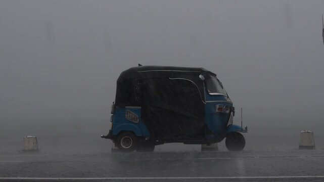 Tuk Tuk Parked on Road During Heavy Rain in Sri Lanka