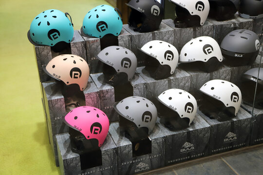 Colorful ski and snowboard helmets for sale in a sporting goods store