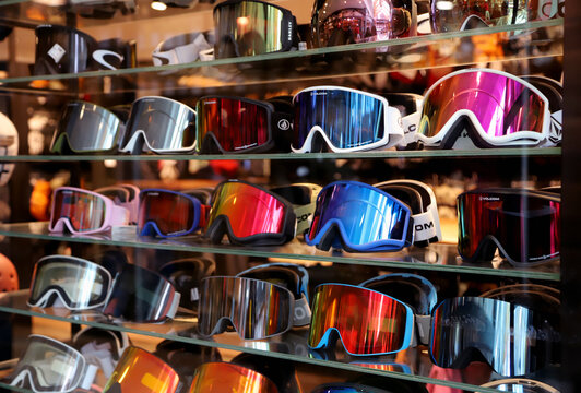 Colorful ski and snowboard goggles displayed in winter sports equipment store
