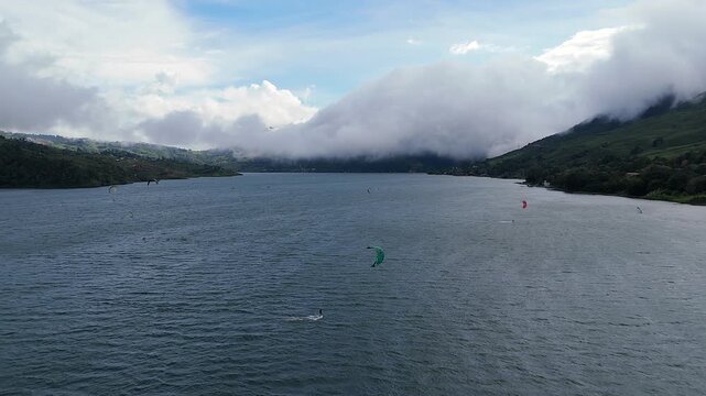 kitesurfing action on lake calima, colombia aerial shot