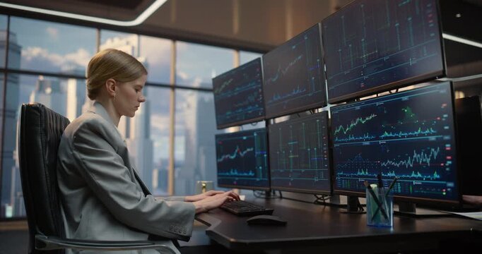 Female Trader and Male Broker Team Work Side by Side at a Trading Desk With Multiple Monitors Streaming Stock Exchange Data, Analyzing Market Charts and Financial Indices for Profit. Arc Shot