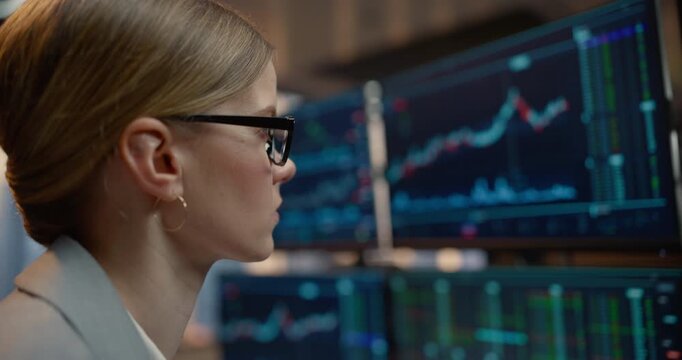 Close-up Profile Portrait of a Female Broker Analyse Stock Exchange Data Across Desk Monitors, Examining Candlestick Charts, Financial Indices, Market Analytics for Profit.  Asset Management Company