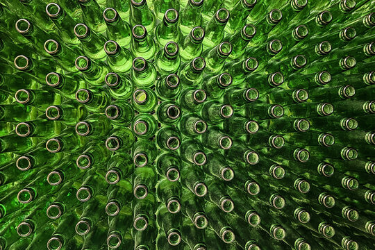 Abstract background of green glass bottles. Concept of glass recycling, reusable bottles, circular economy, bottle deposit return system (Pfand) and sustainable waste management.