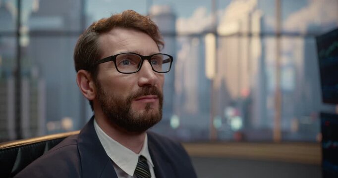 Portrait of Male Stockbroker Seated at His Trading Desk, Contemplating Investment Strategy While Reviewing Stock Exchange Data, Market Charts and Financial Analytics for Capital Growth.