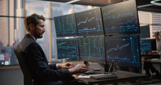 Profile of Thinking Male Stockbroker Examines screens Setup Showing Market Feeds and Price Ticks at His Desk, Thoughtfully Strategizing Equity Trades and Wealth Investment Decisions. Asset Management