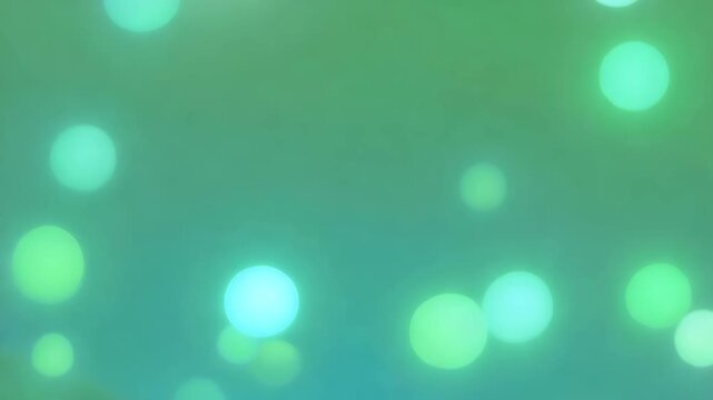 Soft green abstract background with glowing bright blurry bokeh light circles of different sizes, concept of spring freshness