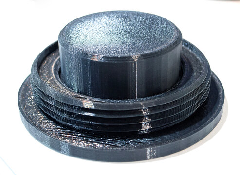 3D printed part from black plastic on 3D printer. Object printed on 3D printer from molten plastic isolated on white background. FDM Fused Deposition Modeling technology. Additive modern manufacturing