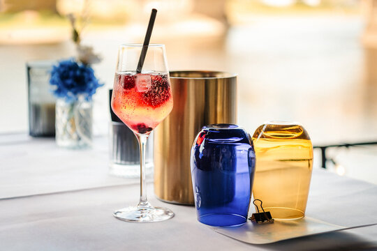 pink cocktail with ice in a glass