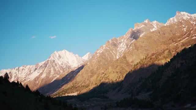 4K Landscape shot of Himalayan mountain peak with snow on top during the sunset as seen from Miyar Valley in Lahaul and Spiti district, Himachal Pradesh, India. Scenic natural background. 