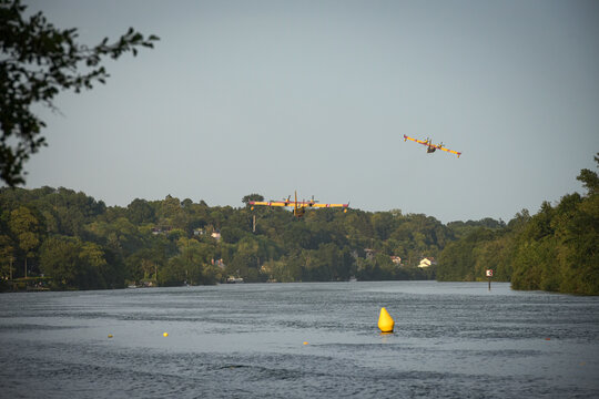 View of the Canadair water bombers scooping water from the Seine during the fires in the Fontainebleau forest