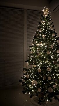 Christmas spruce tree decorated with balls and toys. New Year celebration. Vertical footage