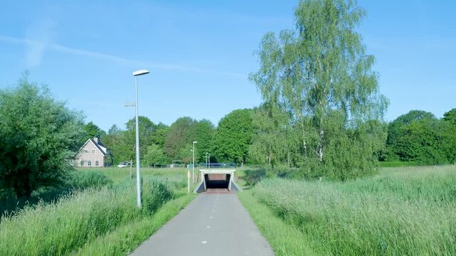 Point of view shot traveling on a cycle path toward an underpass