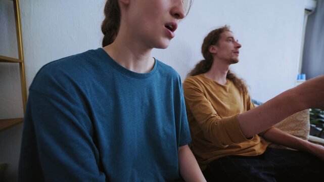 Portrait of a young woman and man sitting on a psychologist's couch during an emotional confrontation