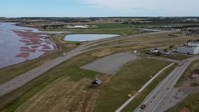 Aerial view of the highway leading to Borden-Carlton coastal town with car traffic in Prince Edward Island Canada