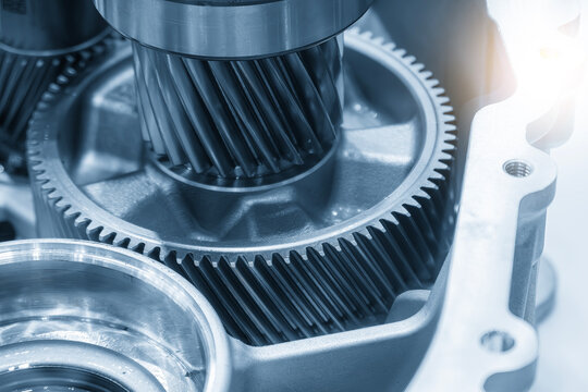 Macro shot of high-precision transmission gear parts in a blue tone scene with a lighting effect.