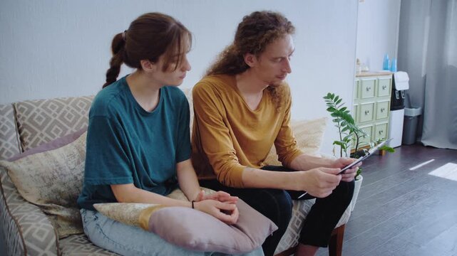 A specialist provides test materials to two people before they complete a questionnaire during a private consultation