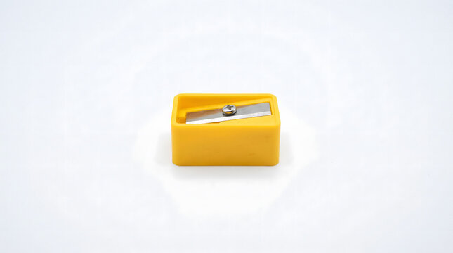 Yellow manual pencil sharpener for office and school use. Classic desktop sharpener with durable metal blade for precise pencil sharpening