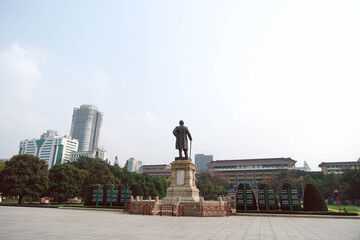 Fototapeta premium Back View of Dr. Sun Yat-sen Bronze Statue and City Skyline in Guangzhou China