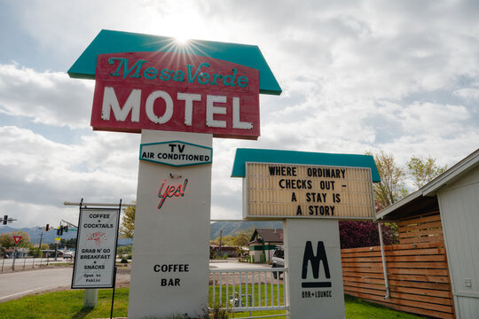 Sunlight shines behind a vintage sign for the Mesa Verde Motel in Mancos, Colorado, May 2025