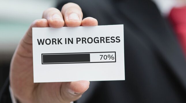 Businessman showing a work in progress status bar at seventy percent completion as a professional project management concept